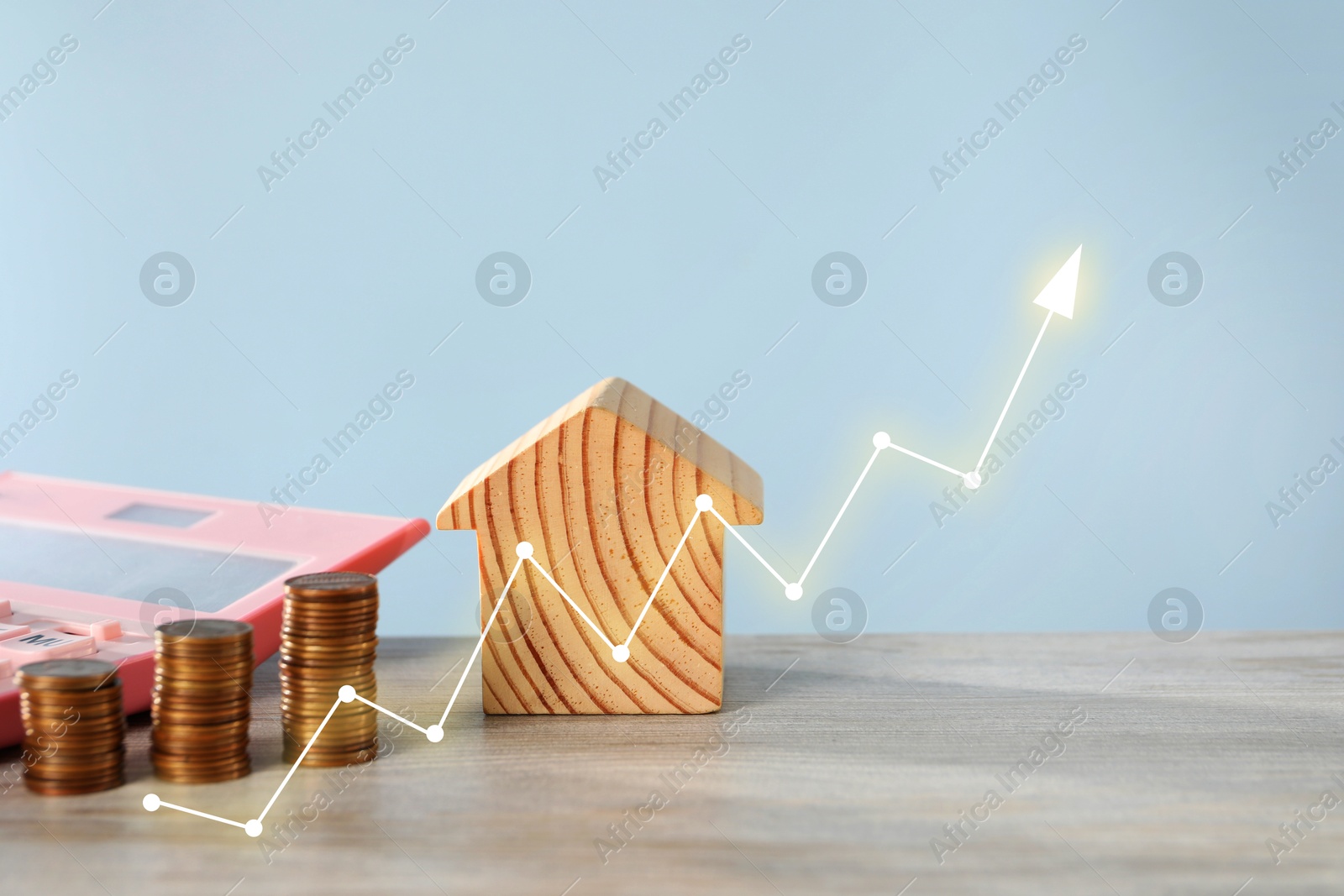 Increase in real estate value. House model, coins and calculator on table. Growing price represented by arrow Image of Increase in real estate value. House model, coins and calculator on table. Growing price represented by arrow
