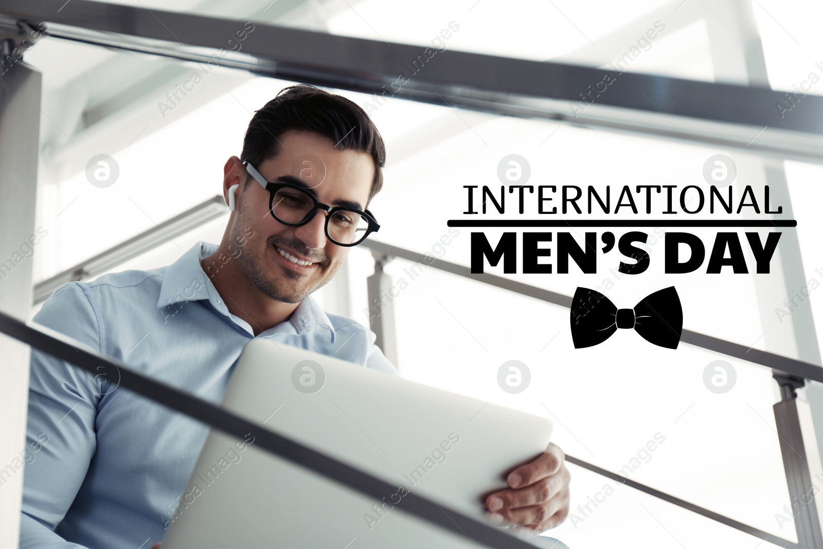 International Men's Day card with bowtie illustration. Happy man using laptop indoors Image of International Men's Day card with bowtie illustration. Happy man using laptop indoors