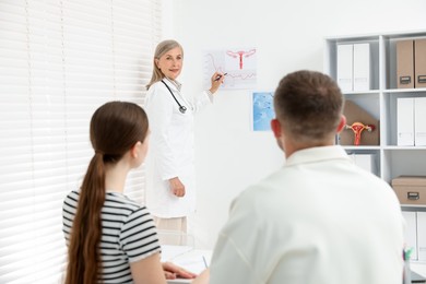 Photo of In vitro fertilization (IVF). Couple having consultation with doctor in reproductive clinic, selective focus