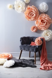 Photo of Photo zone with stylish floral decor and armchair in studio