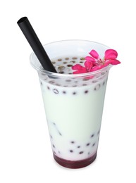 Photo of Tasty refreshing bubble tea and flower isolated on white