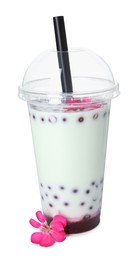 Photo of Tasty refreshing bubble tea and flower isolated on white