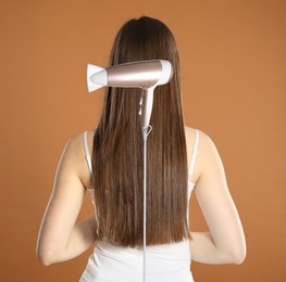 Image of Before and after hair styling. Photo of woman divided by hair dryer against brown background