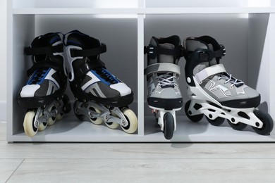 Photo of Pairs of roller skates in shelving unit, closeup