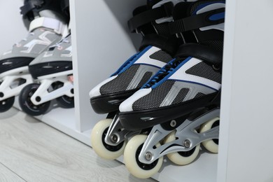 Photo of Pairs of roller skates in shelving unit, closeup
