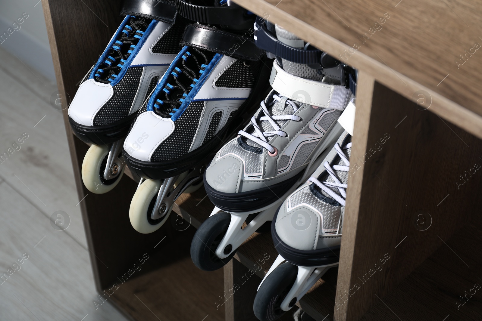Photo of Pairs of roller skates in shelving unit, closeup