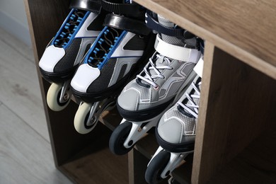 Photo of Pairs of roller skates in shelving unit, closeup