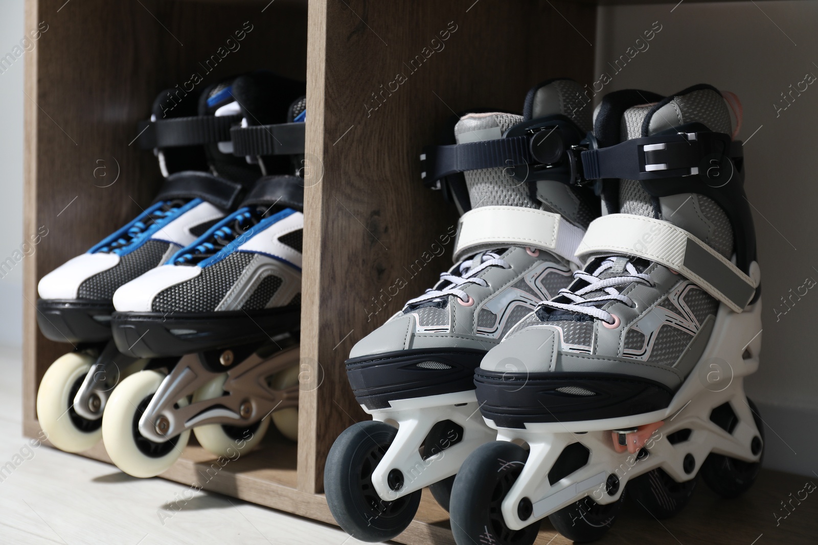 Pairs of roller skates in shelving unit, closeup Photo of Pairs of roller skates in shelving unit, closeup