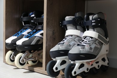 Photo of Pairs of roller skates in shelving unit, closeup