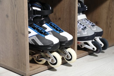 Photo of Pairs of roller skates in shelving unit, closeup