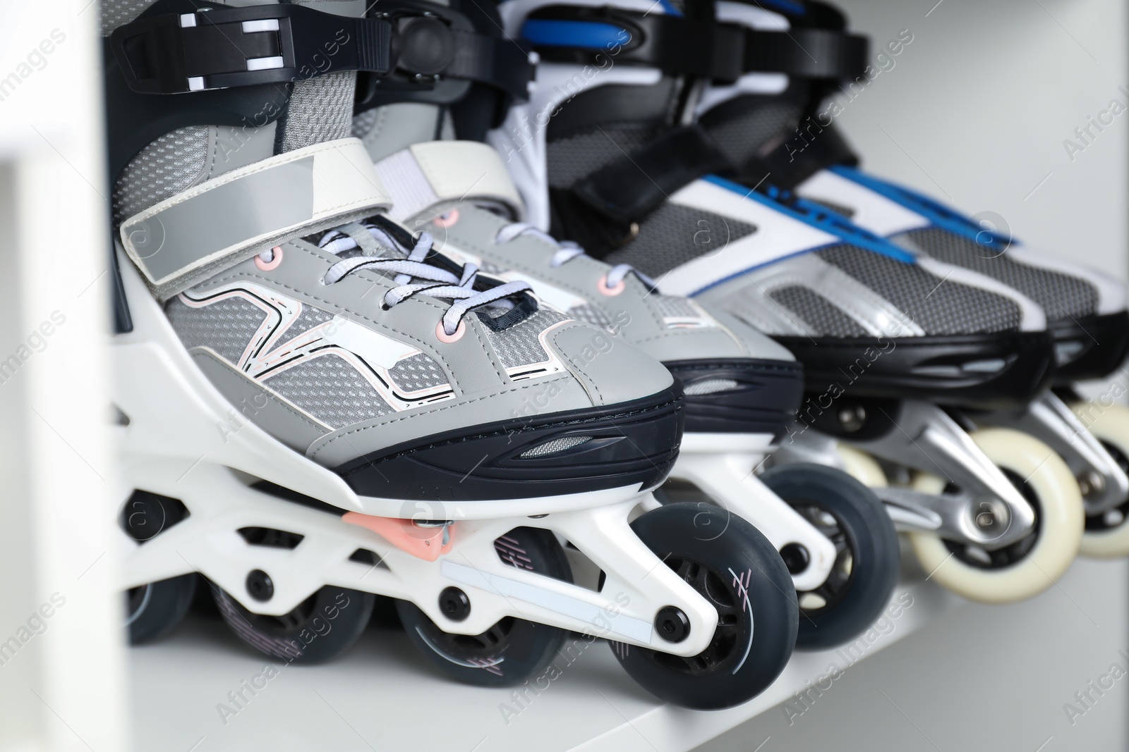 Pairs of roller skates in shelving unit, closeup Photo of Pairs of roller skates in shelving unit, closeup