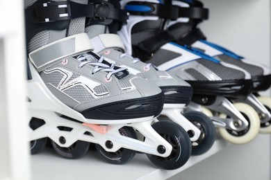 Photo of Pairs of roller skates in shelving unit, closeup