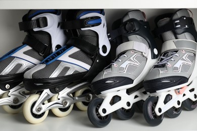 Photo of Pairs of roller skates in shelving unit, closeup