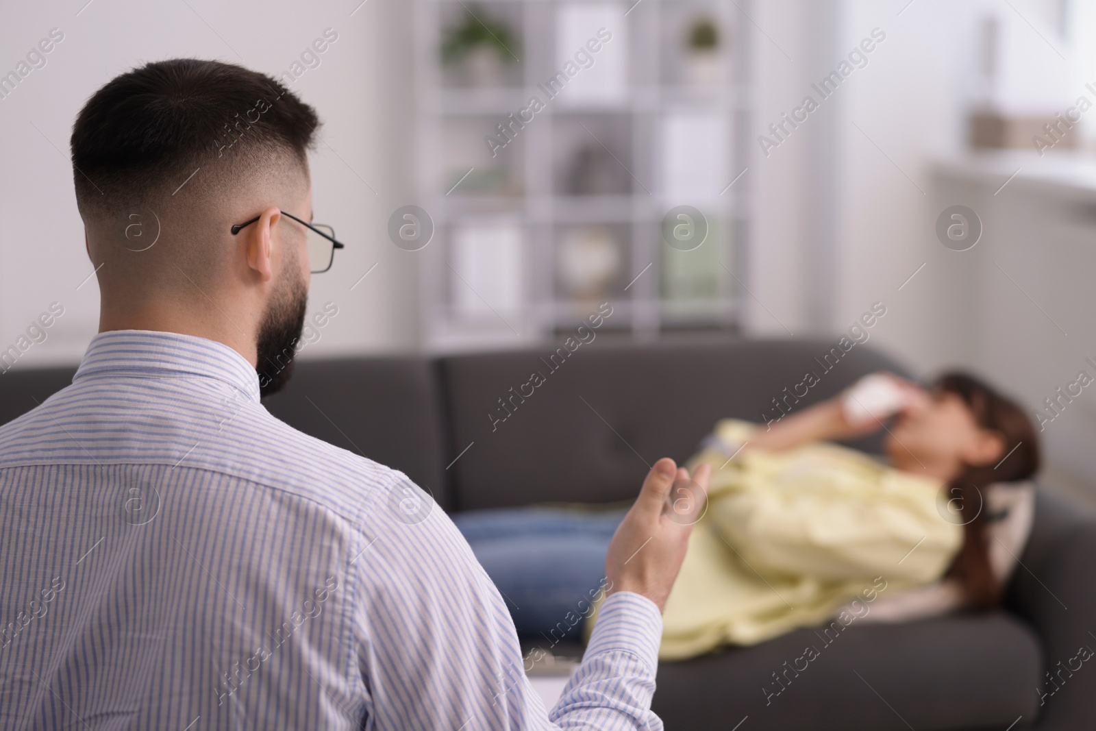 Photo of Professional psychologist working with patient in office, selective focus