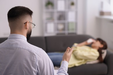 Photo of Professional psychologist working with patient in office, selective focus