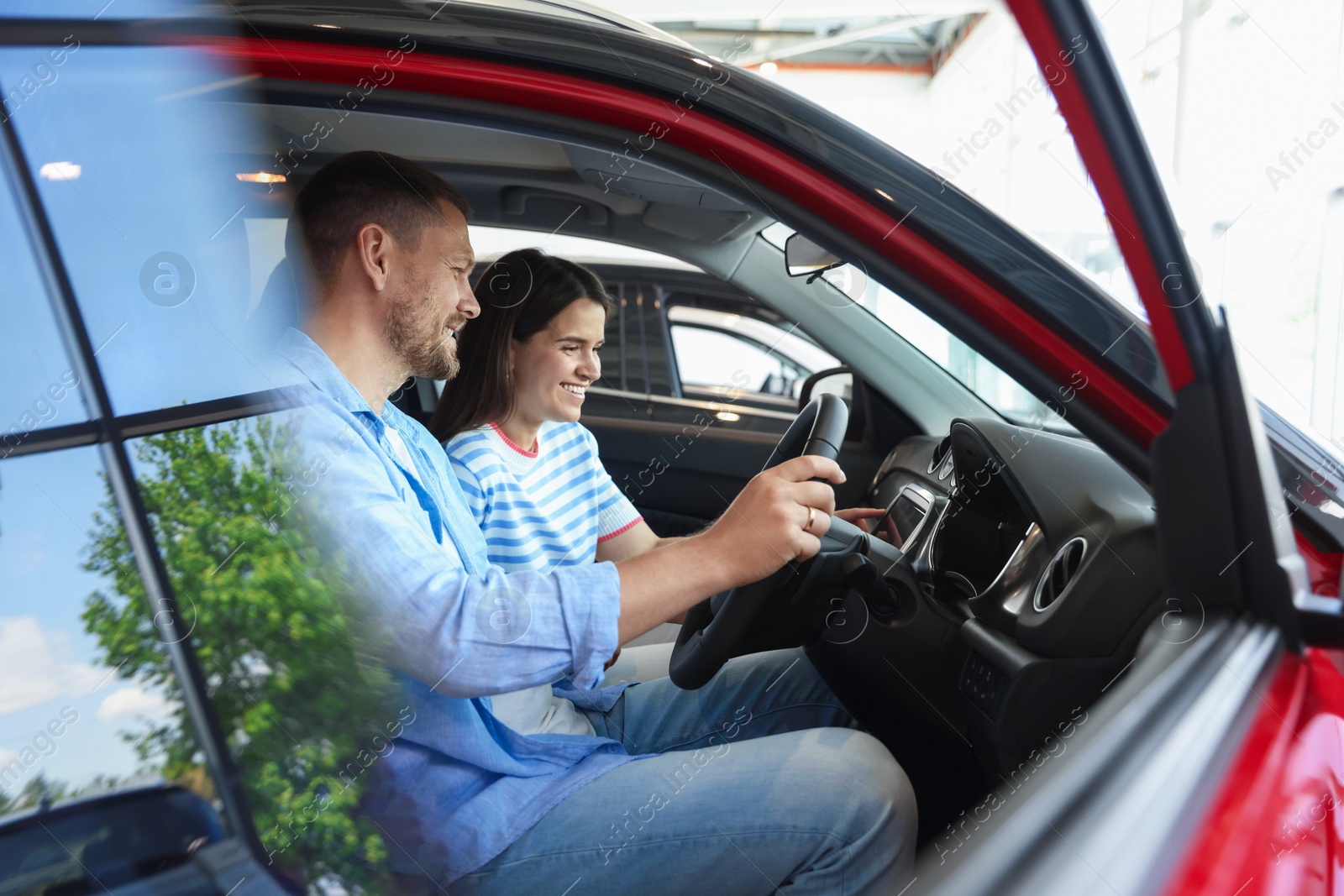 Happy family sitting inside new car. Luxury vehicle Photo of Happy family sitting inside new car. Luxury vehicle