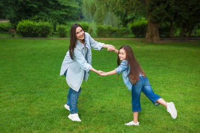 Photo of Family getaway. Happy mother and daughter spending time together in park