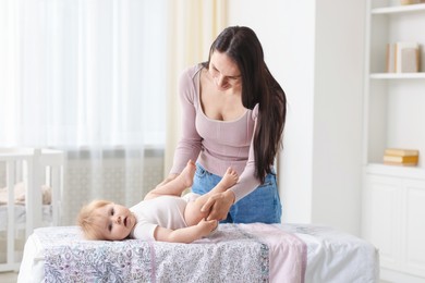 Photo of Mother with her cute baby at home