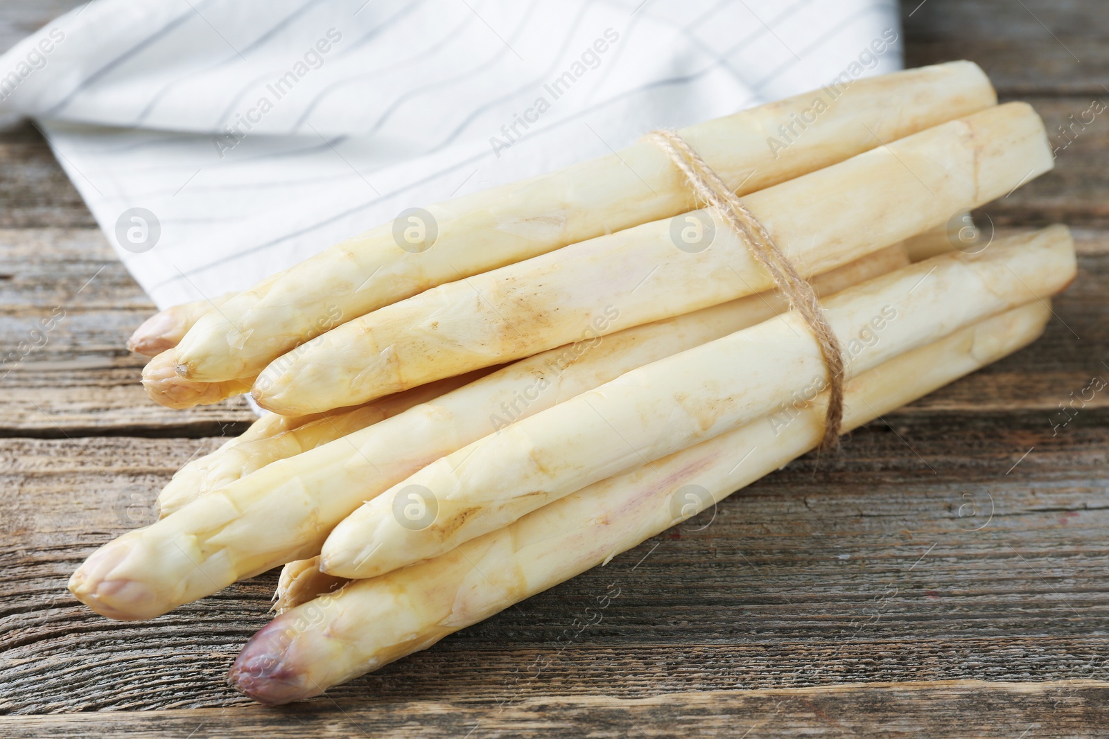 Raw white asparagus spears on wooden table, closeup Photo of Raw white asparagus spears on wooden table, closeup