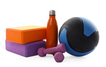 Photo of Medicine ball, dumbbells, foam blocks and water bottle isolated on white