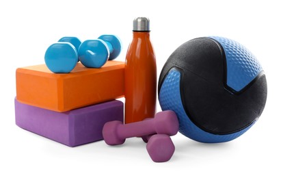 Photo of Medicine ball, dumbbells, foam blocks and water bottle isolated on white