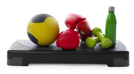 Photo of Medicine ball, dumbbells, boxing gloves, water bottle and step platform isolated on white