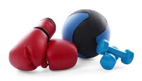 Photo of Medicine ball, dumbbells and boxing gloves isolated on white
