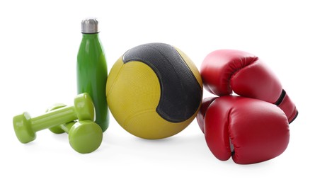 Photo of Medicine ball, dumbbells, boxing gloves and water bottle isolated on white