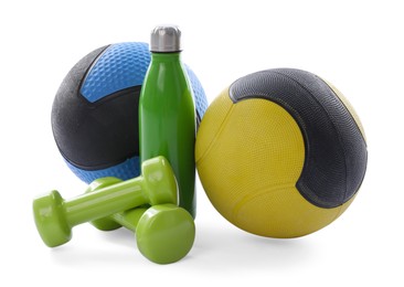 Photo of Medicine balls, dumbbells and water bottle isolated on white