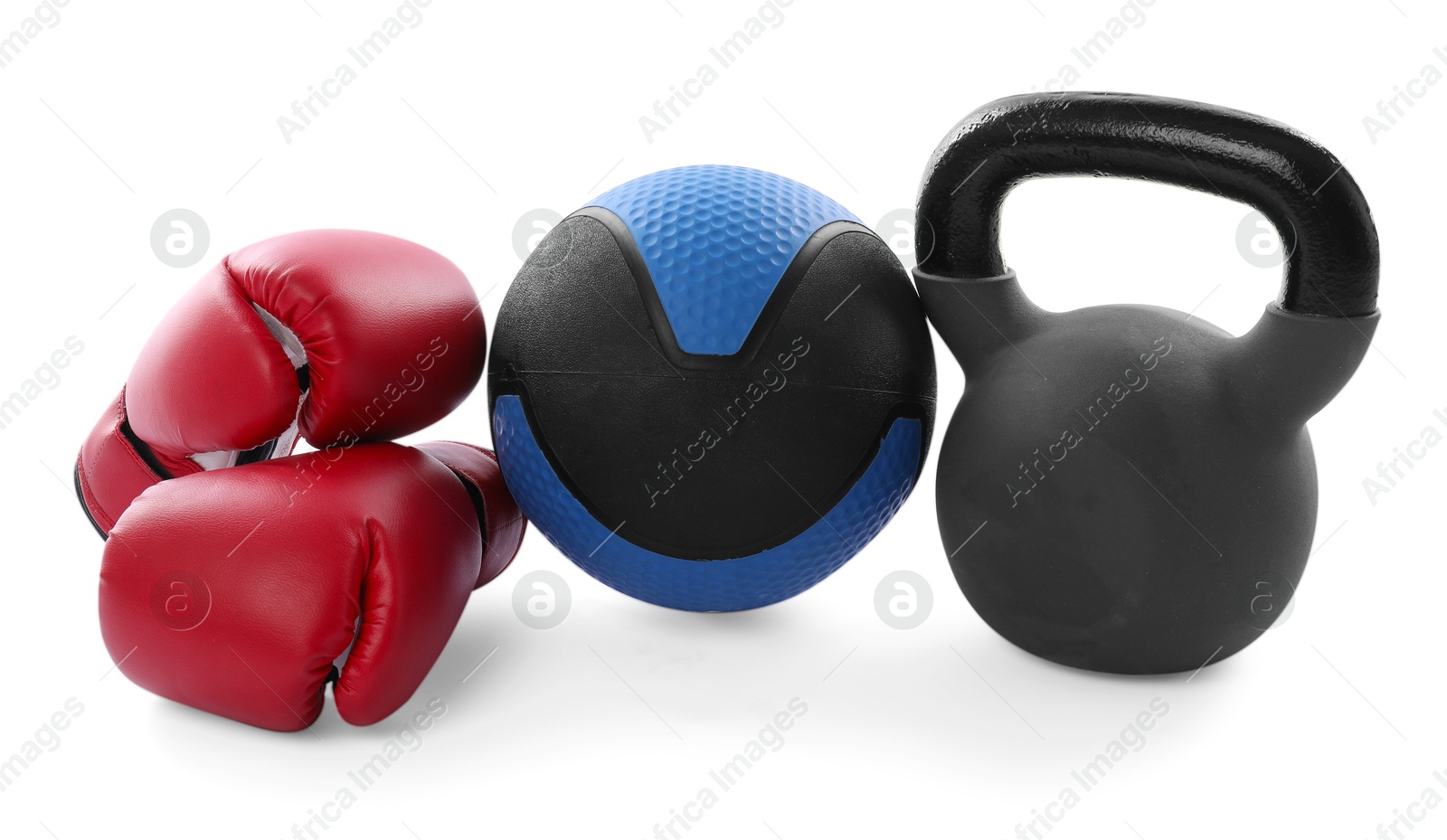 Photo of Medicine ball, kettlebell and boxing gloves isolated on white
