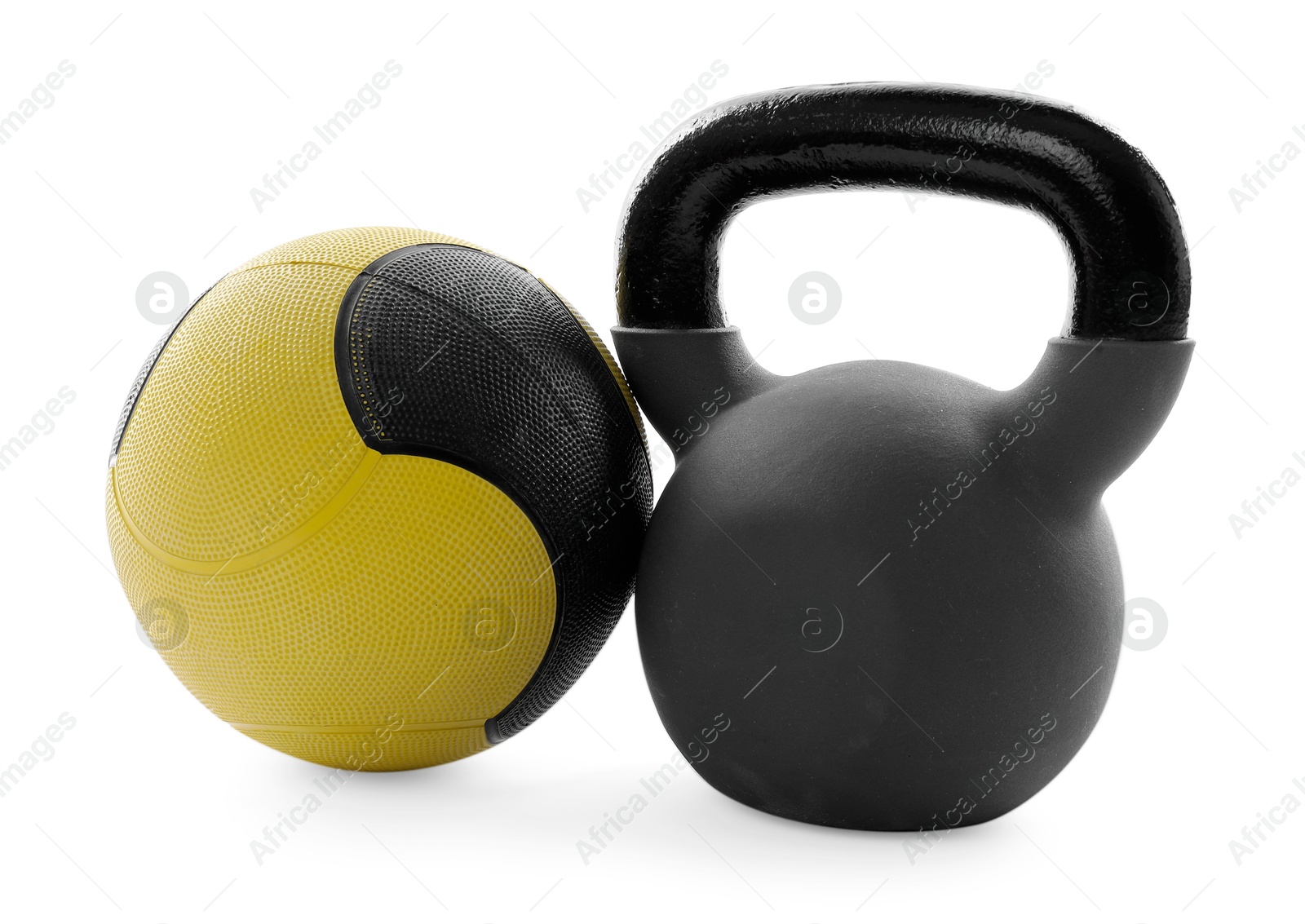 Medicine ball and kettlebell isolated on white Photo of Medicine ball and kettlebell isolated on white