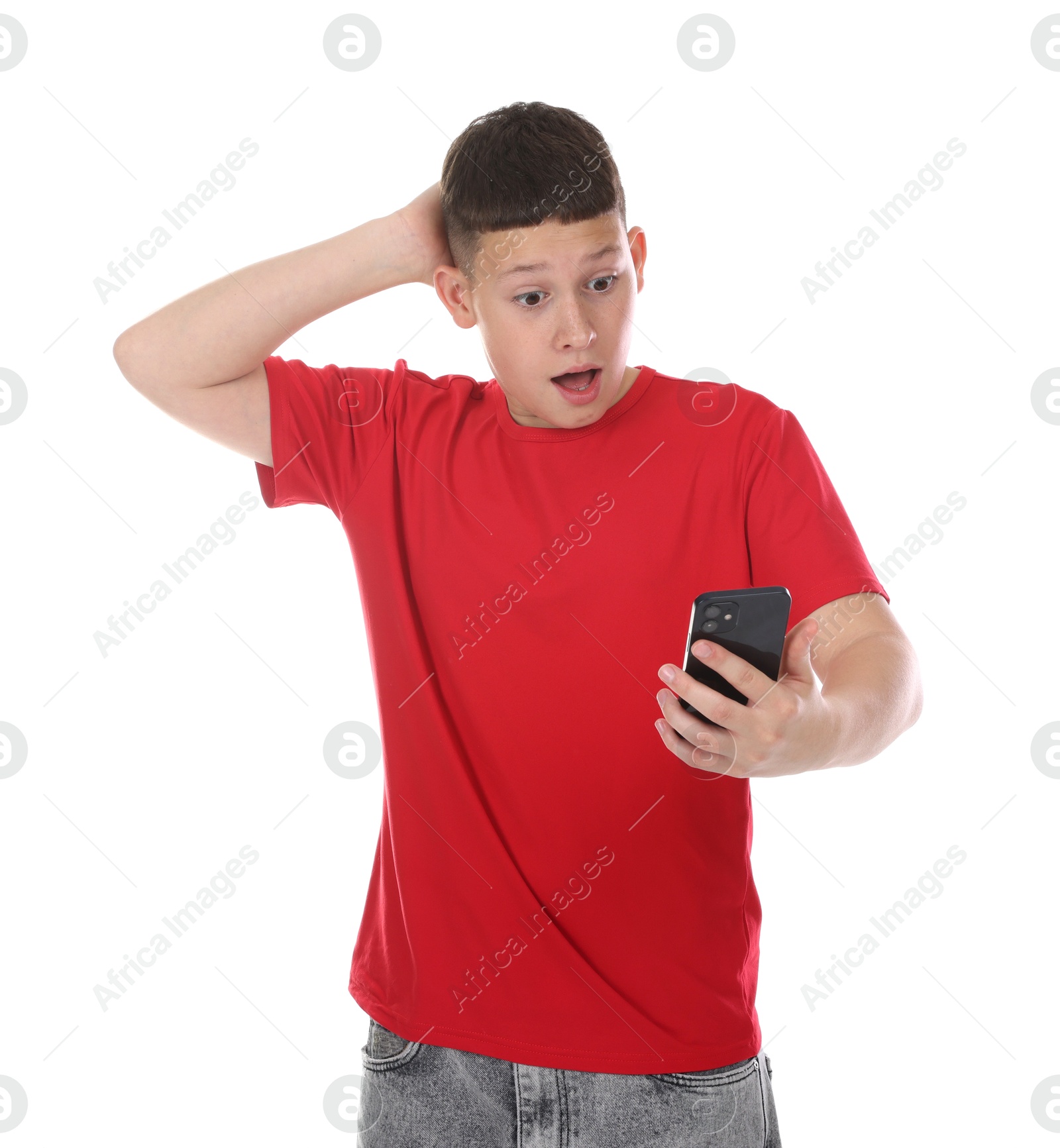Teenage boy with smartphone on white background Photo of Teenage boy with smartphone on white background