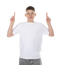 Photo of Teenage boy pointing at something on white background