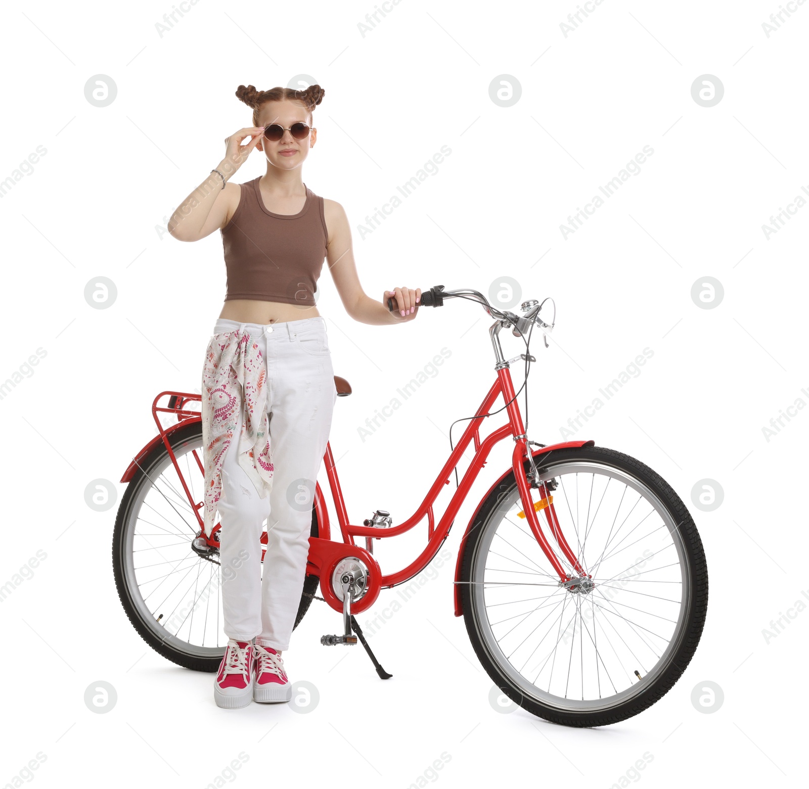 Teenage girl with red bicycle on white background Photo of Teenage girl with red bicycle on white background