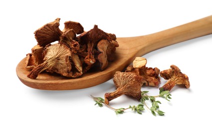 Photo of Dried chanterelle mushrooms and thyme isolated on white