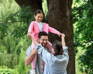 Photo of Happy family spending time together in park
