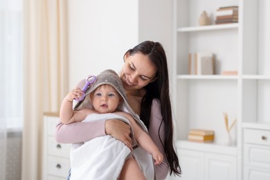 Photo of Mother with her cute baby at home