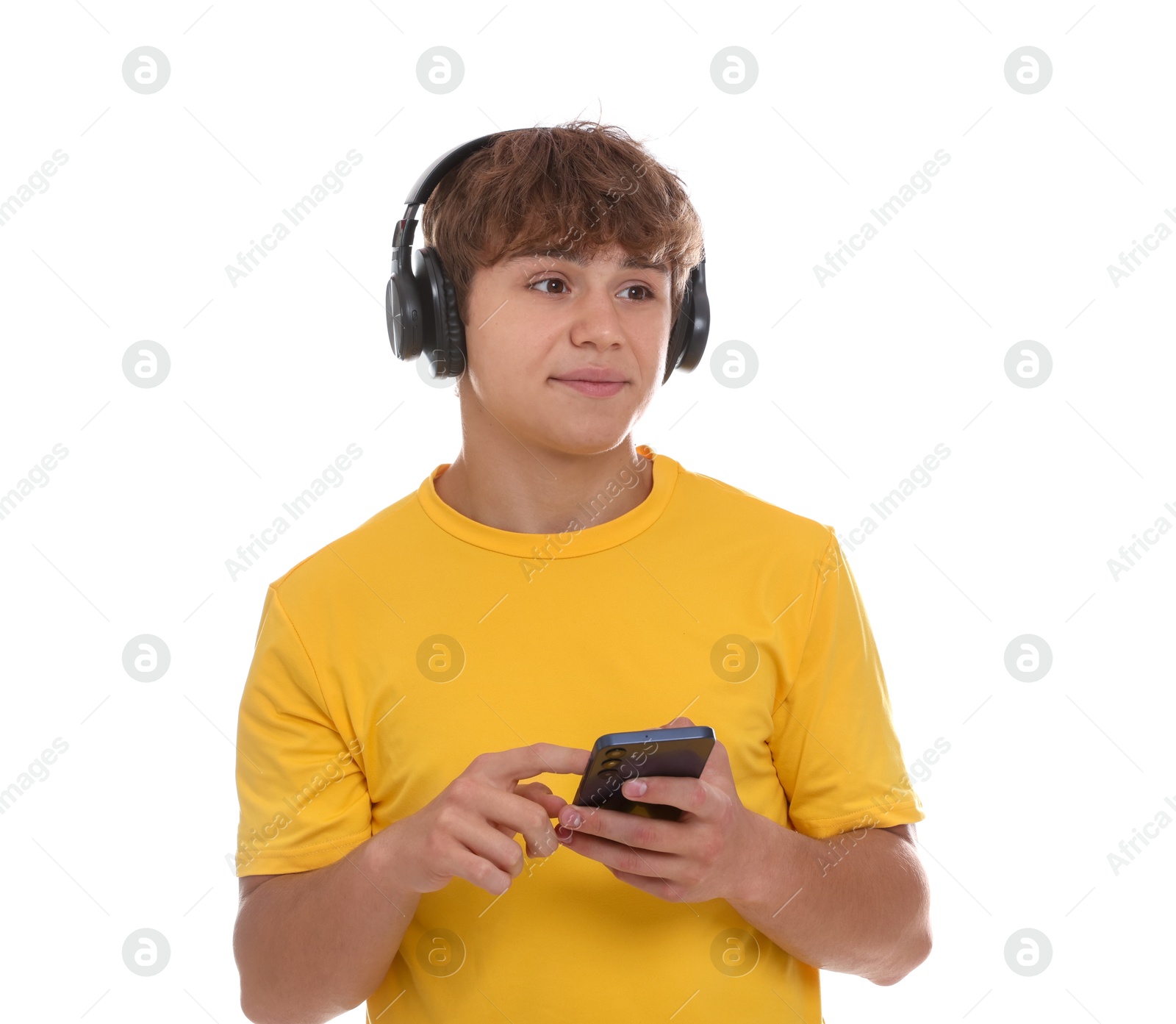 Photo of Teenage boy in headphones with smartphone on white background