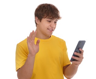 Photo of Smiling teenage boy with smartphone waving hello on white background