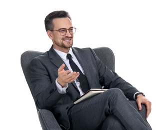 Photo of Professional psychologist with notebook in armchair on white background