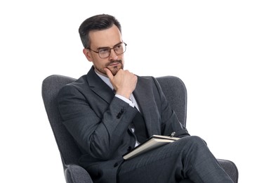 Photo of Professional psychologist with notebook in armchair on white background