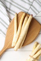 Photo of Raw asparagus spears on white wooden table, flat lay