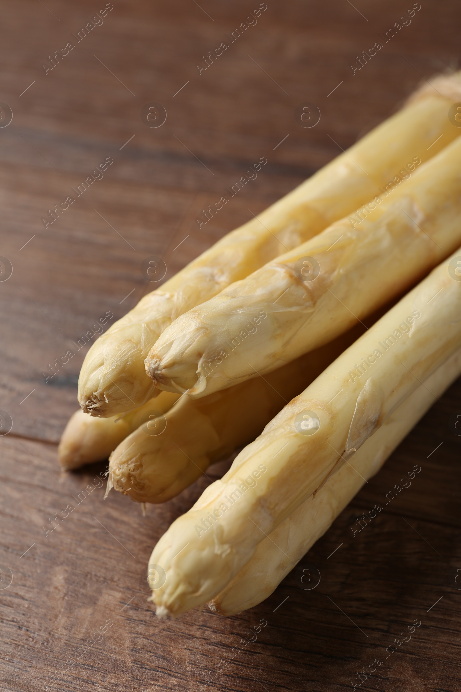Raw white asparagus spears on wooden table, closeup Photo of Raw white asparagus spears on wooden table, closeup