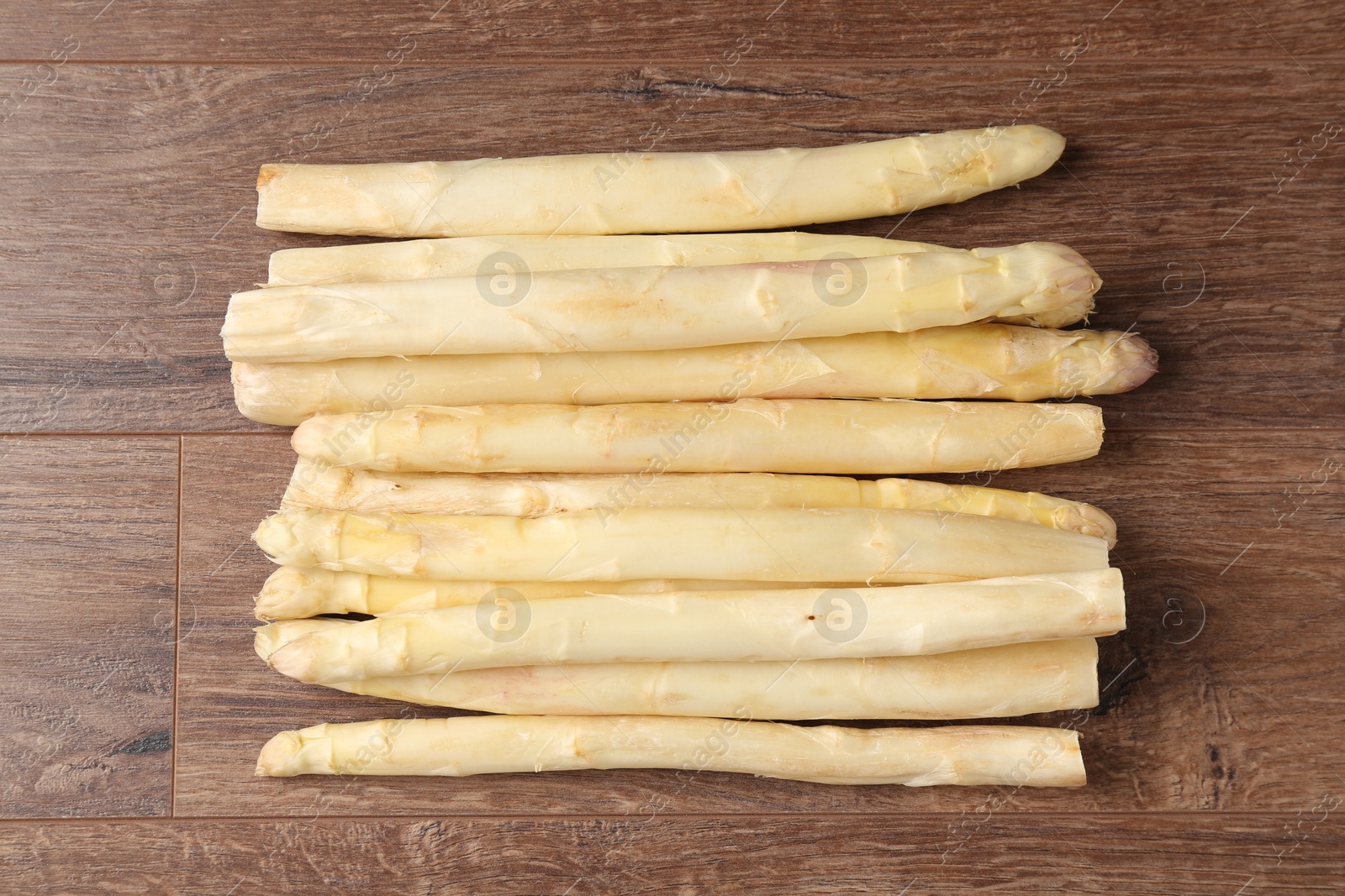 Raw white asparagus spears on wooden table, top view Photo of Raw white asparagus spears on wooden table, top view