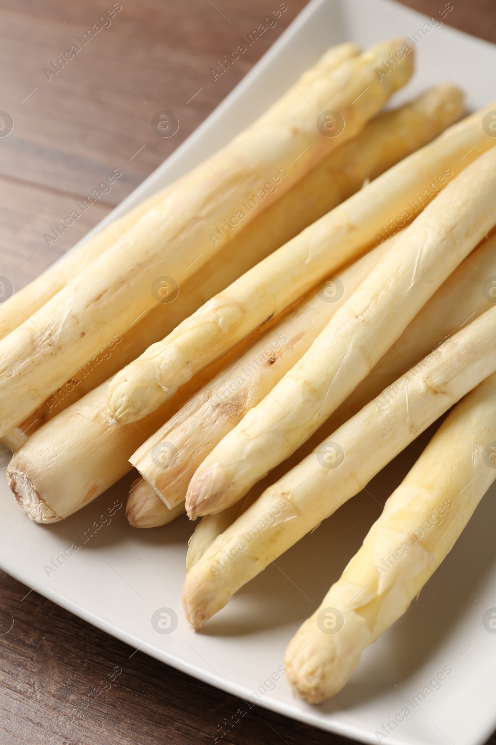 Raw white asparagus spears on wooden table, closeup Photo of Raw white asparagus spears on wooden table, closeup
