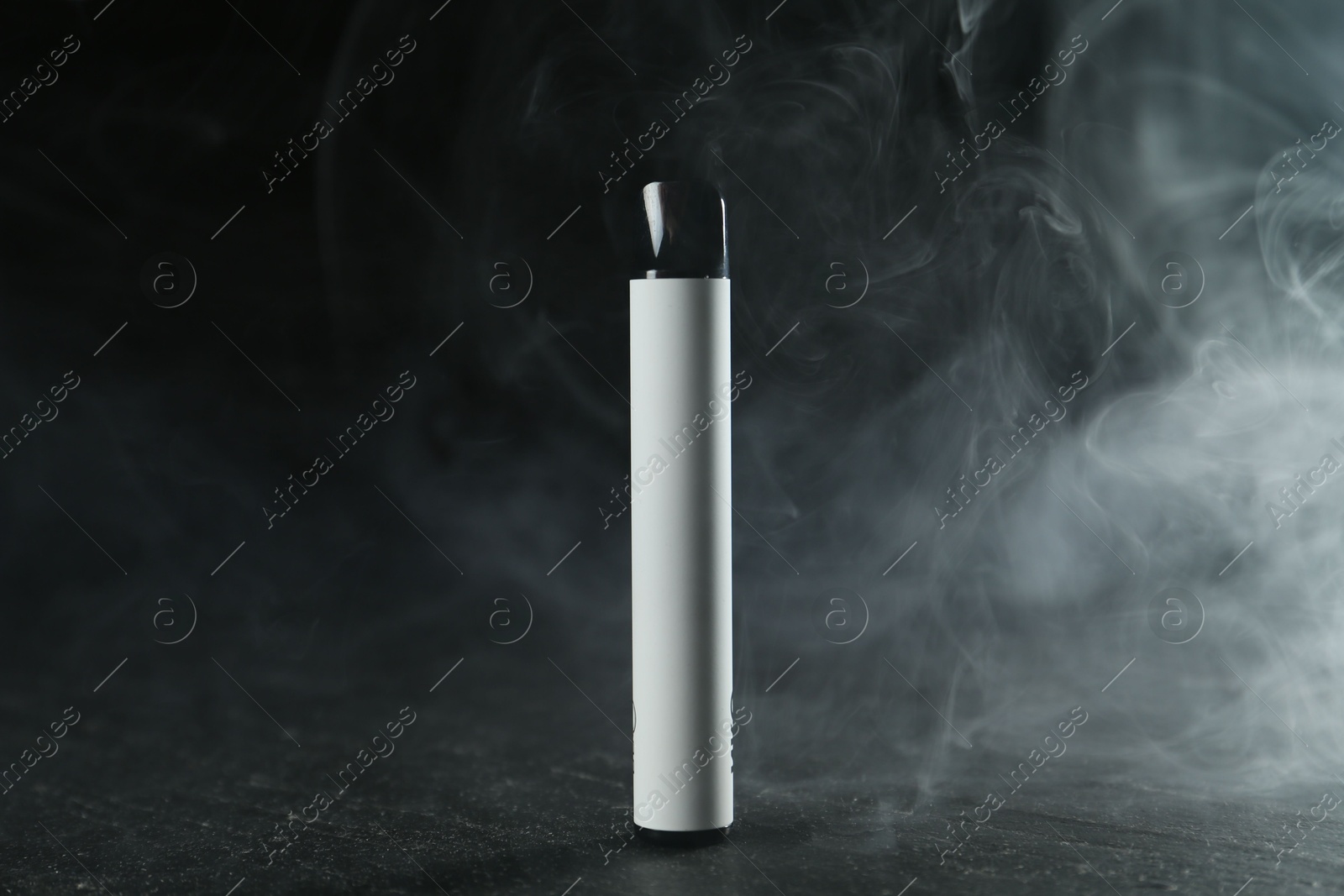 Modern electronic smoking device on black table Photo of Modern electronic smoking device on black table