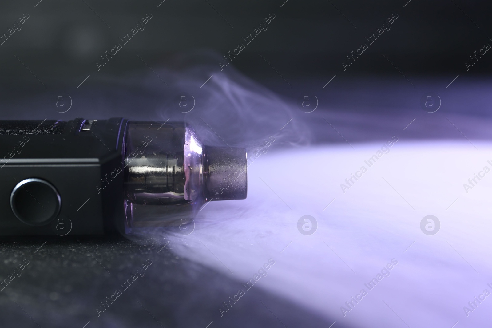 Modern electronic smoking device on black table, closeup. Space for text Photo of Modern electronic smoking device on black table, closeup. Space for text