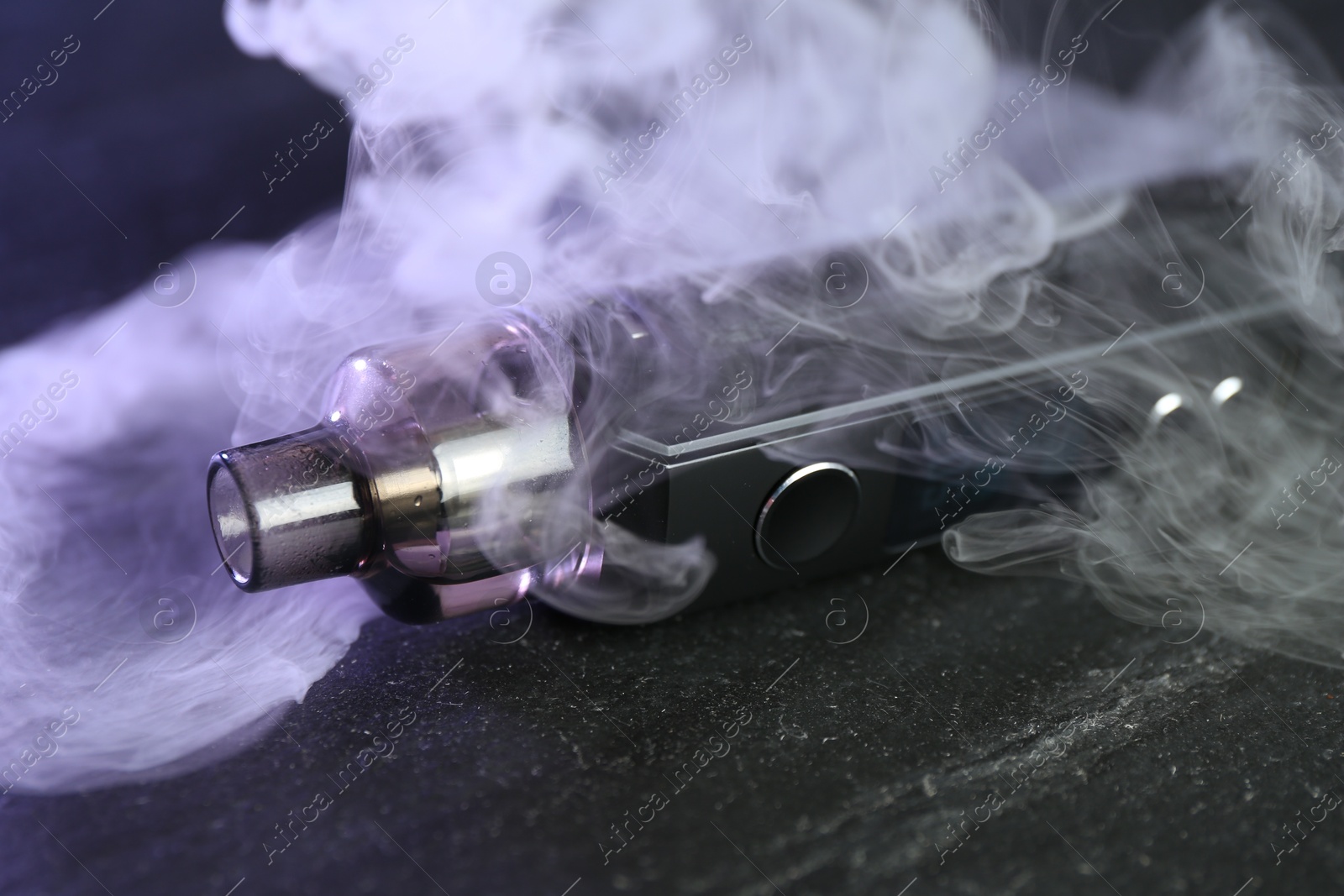 Modern electronic smoking device on black table, closeup Photo of Modern electronic smoking device on black table, closeup