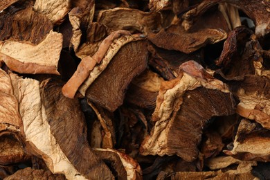 Photo of Pieces of dried mushrooms as background, top view