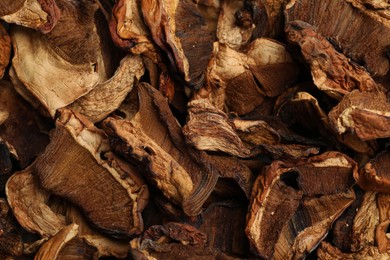 Photo of Pieces of dried mushrooms as background, top view